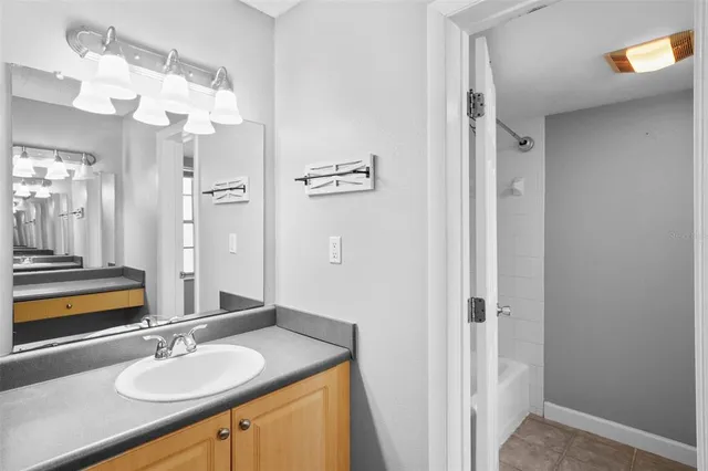 a bedroom with bed and painting on the wall