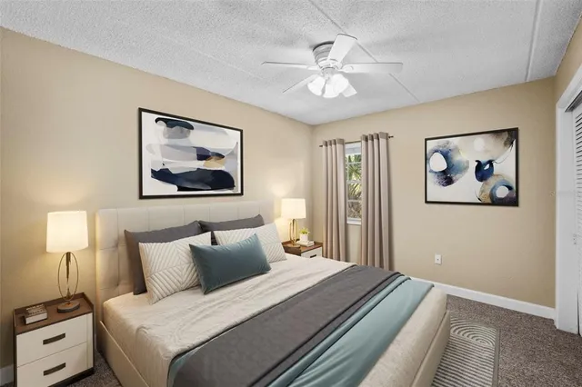 a view of an empty room with a chandelier fan
