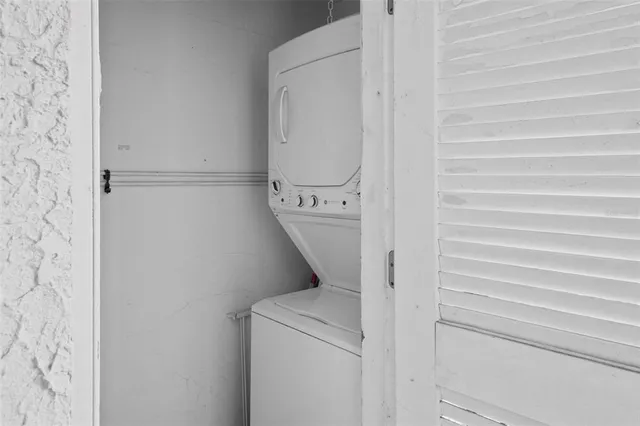 a view of an empty room with stairs and furniture