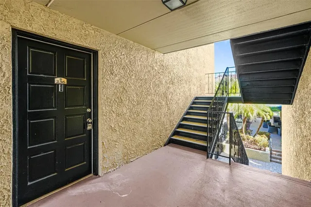 a view of a house with swimming pool and sitting area