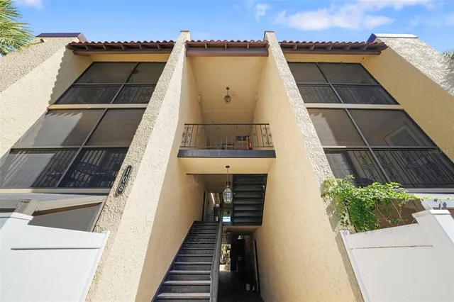 a view of a porch with a table and chairs