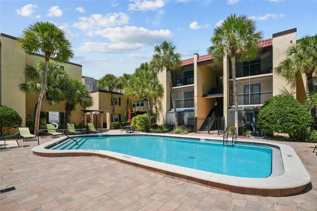 a view of swimming pool with outdoor seating and a patio