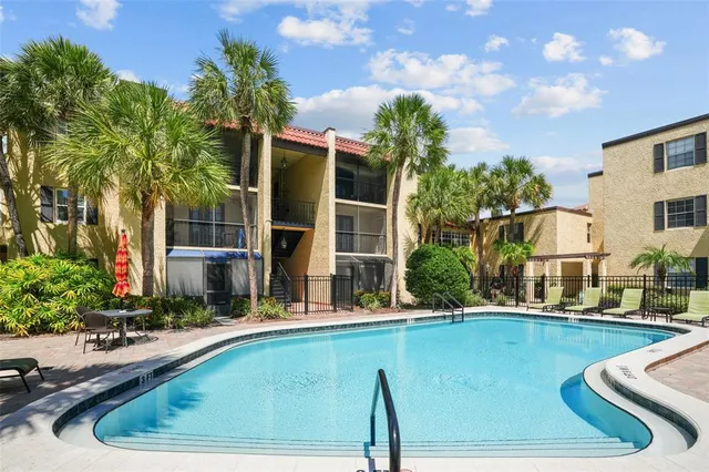 a view of a house with backyard and trees