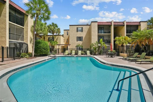 a view of swimming pool with outdoor seating and plants