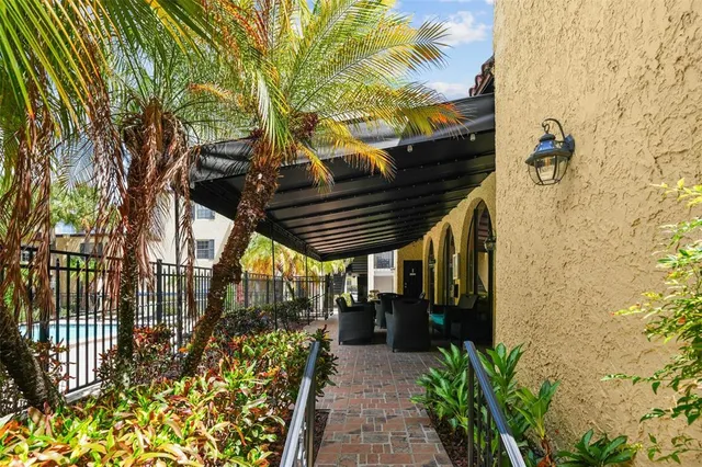 a dining room with furniture and a floor to ceiling window