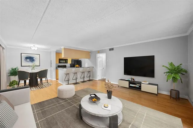 a kitchen with stainless steel appliances granite countertop a stove and a wooden floors