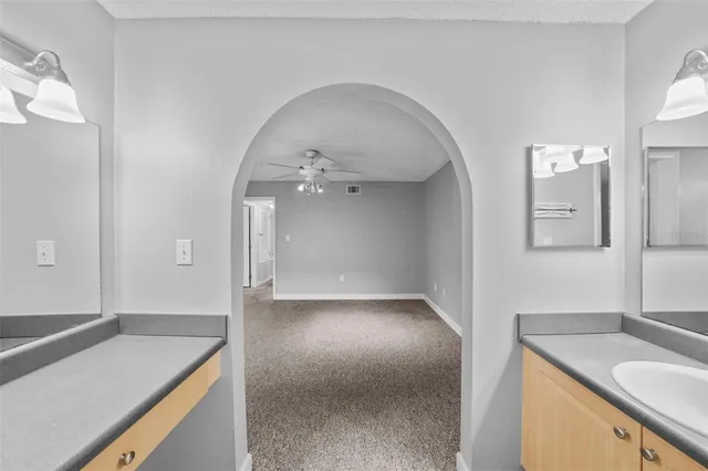 a kitchen with granite countertop a refrigerator stove and microwave