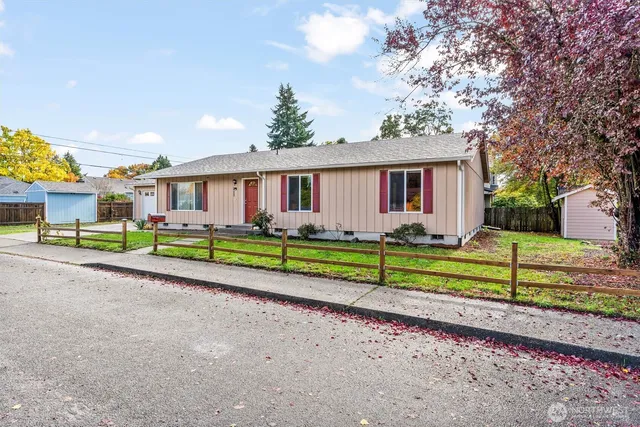 a front view of a house with a yard and potted plants