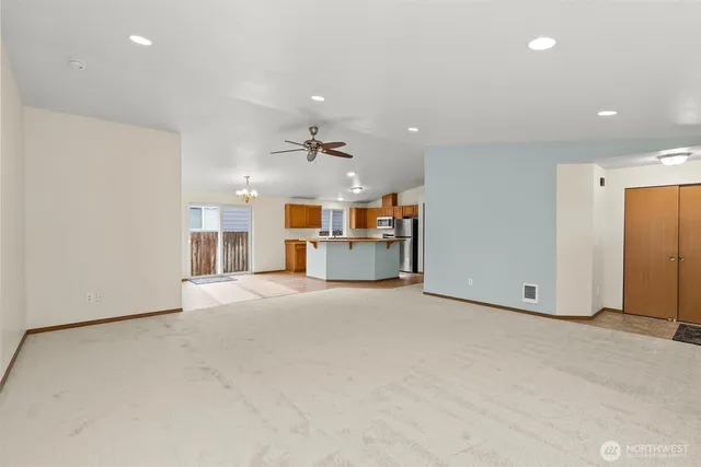 a view of a livingroom with furniture and a ceiling fan