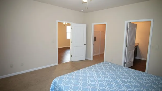 a large bed sitting in a bathroom next to a window