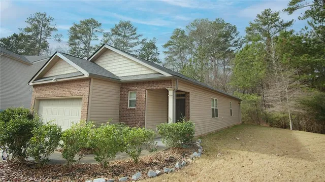 a front view of a house with garden