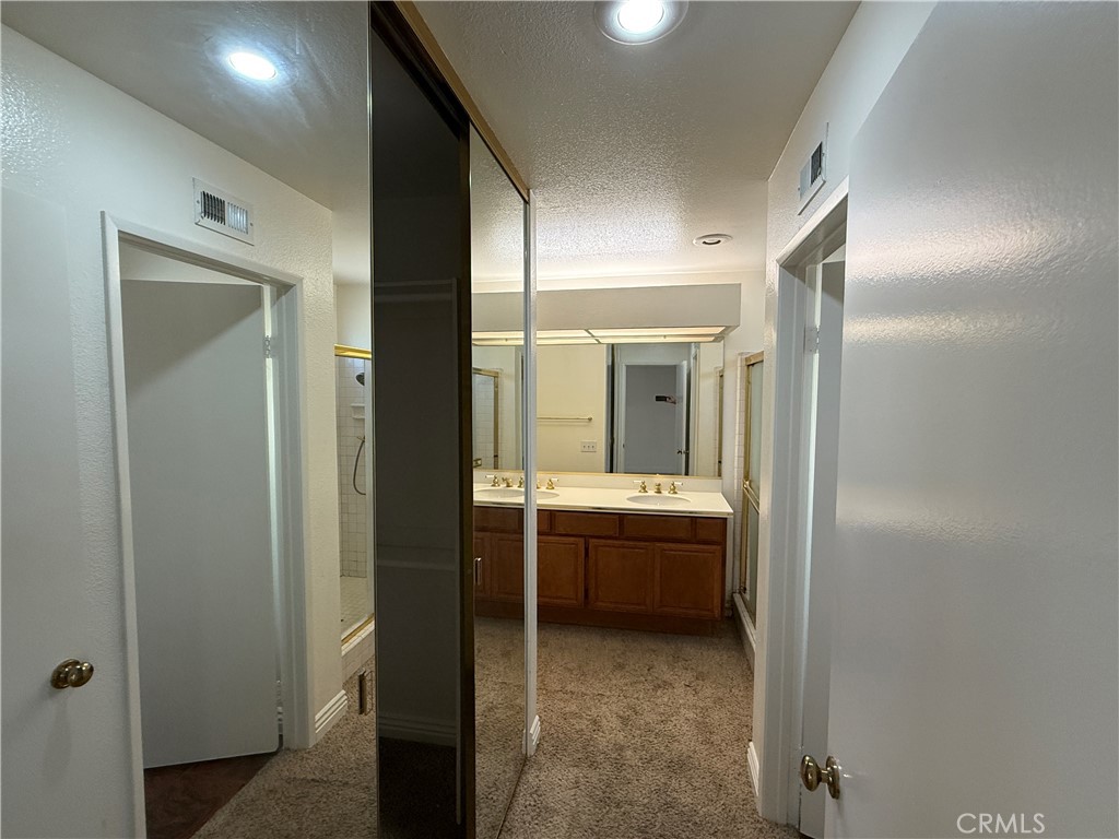 24315 Taranto Avenue Valencia, CA 91355 - Photo 13 of 21 a bathroom with a granite countertop sink and mirror