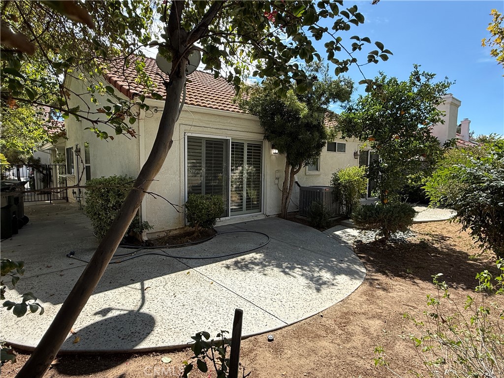 24315 Taranto Avenue Valencia, CA 91355 - Photo 18 of 21 a front view of a house with trees