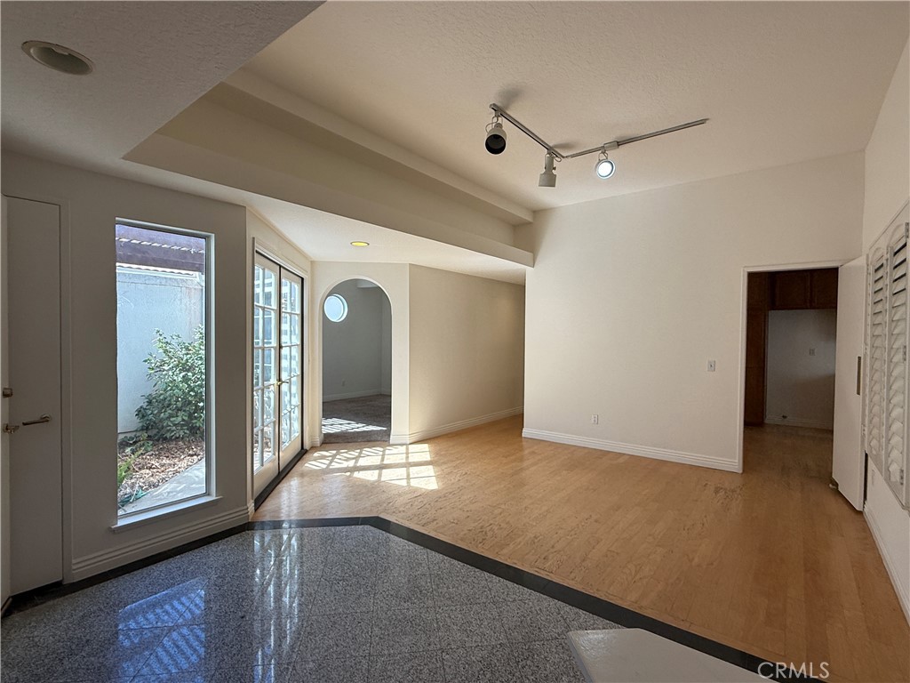 24315 Taranto Avenue Valencia, CA 91355 - Photo 2 of 21 an empty room with windows and entrance