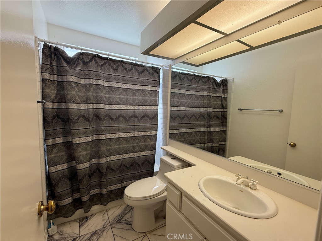 24315 Taranto Avenue Valencia, CA 91355 - Photo 8 of 21 a bathroom with a toilet a sink and shower