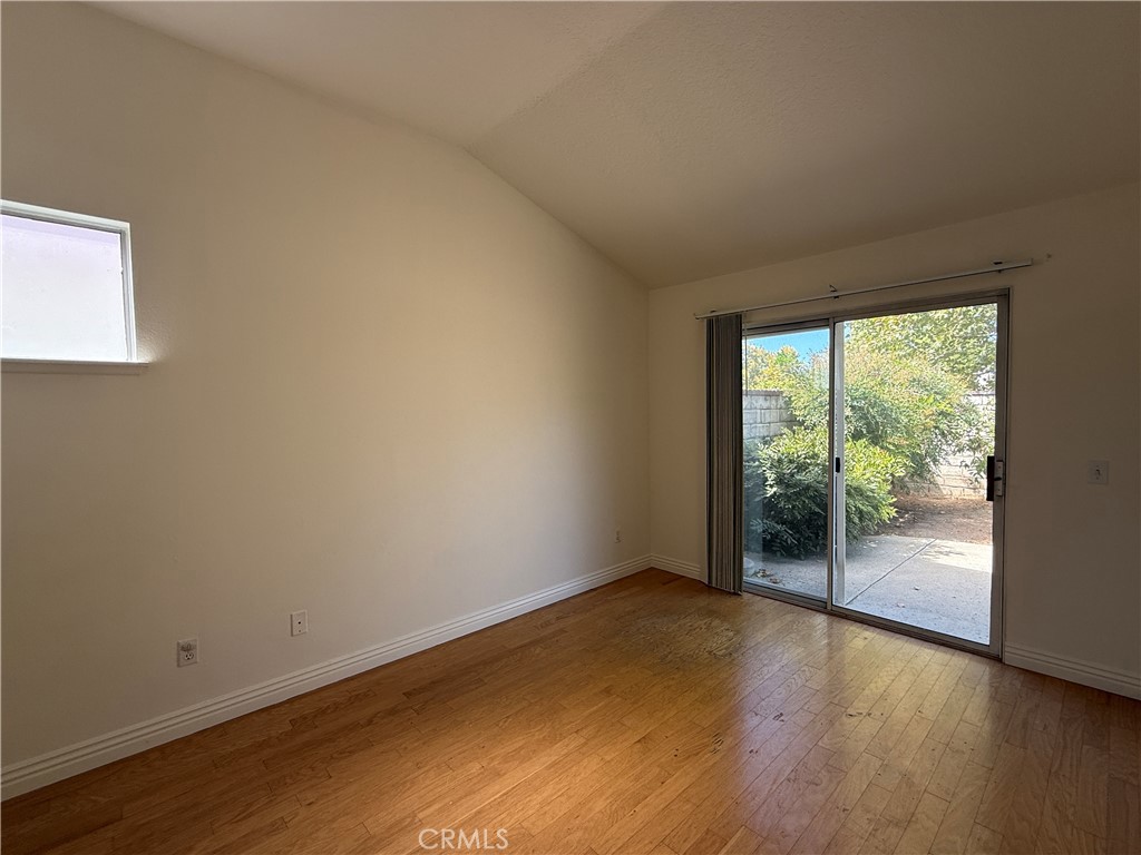 24315 Taranto Avenue Valencia, CA 91355 - Photo 9 of 21 a view of an empty room with wooden floor and a window