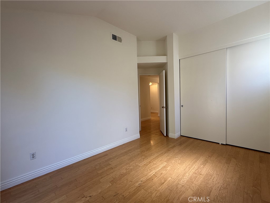 24315 Taranto Avenue Valencia, CA 91355 - Photo 10 of 21 an empty room with wooden floor and closet area