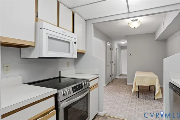 a kitchen with stainless steel appliances granite countertop a stove and a microwave