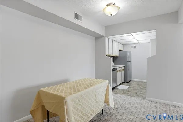 a kitchen with a refrigerator and a sink
