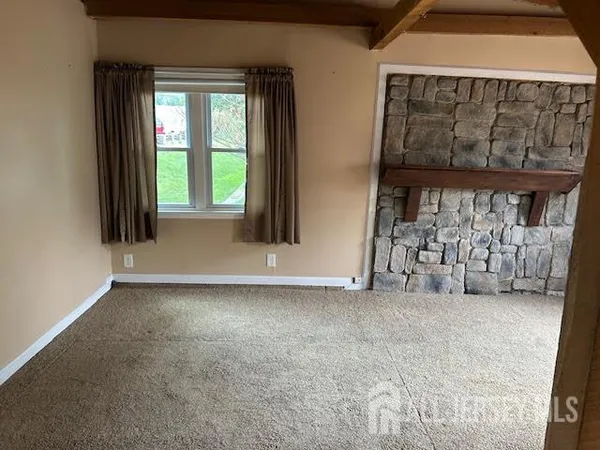 a bathroom with a granite countertop toilet sink and mirror