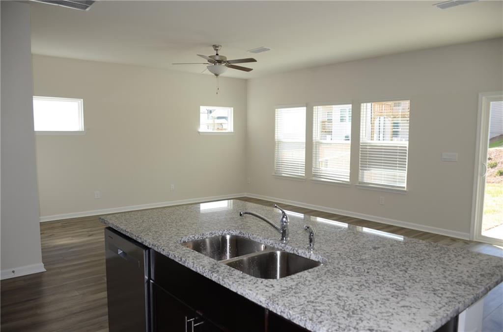 226 Wells Circle Canton, GA 30114 - Photo 11 of 27 a kitchen with a sink granite counter top space and a window