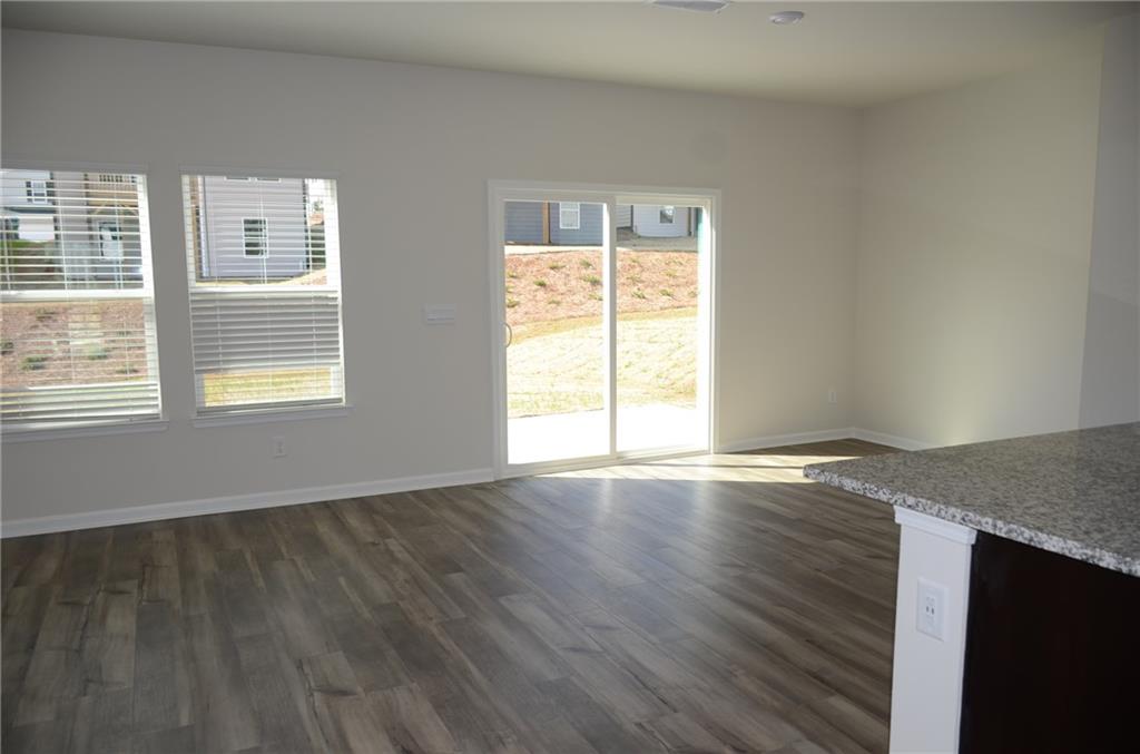 226 Wells Circle Canton, GA 30114 - Photo 12 of 27 a view of an empty room with wooden floor and a window