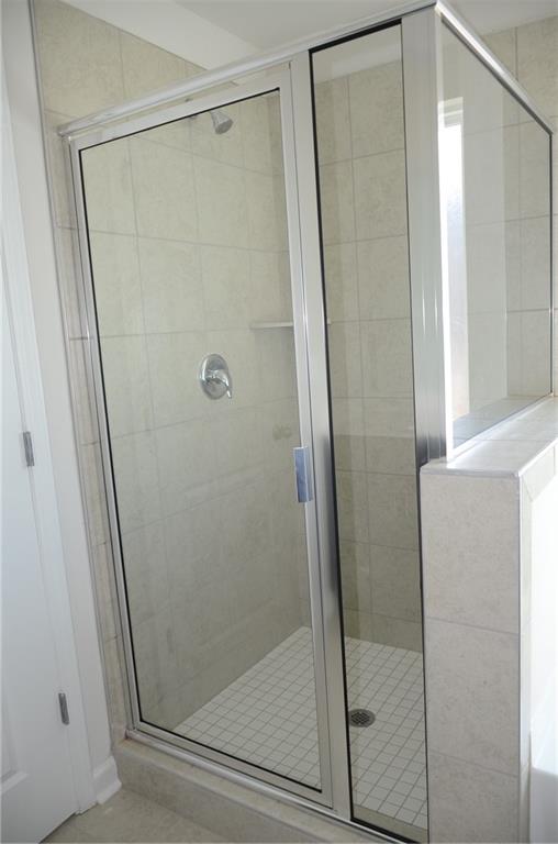 226 Wells Circle Canton, GA 30114 - Photo 18 of 27 a bathroom with a glass shower door