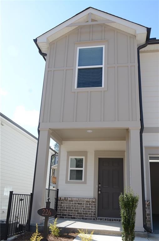 226 Wells Circle Canton, GA 30114 - Photo 2 of 27 a front view of a house with garden