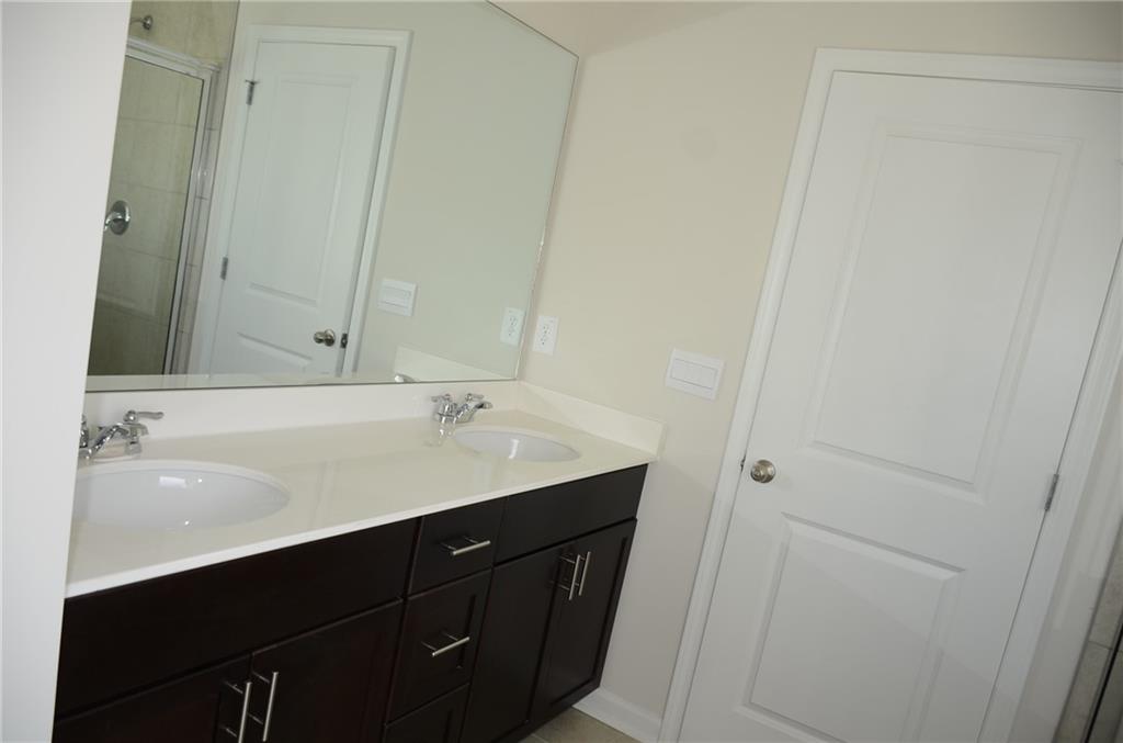 226 Wells Circle Canton, GA 30114 - Photo 21 of 27 a bathroom with a sink and a mirror