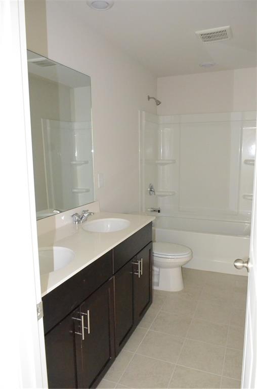 226 Wells Circle Canton, GA 30114 - Photo 22 of 27 a bathroom with a double vanity sink toilet and shower