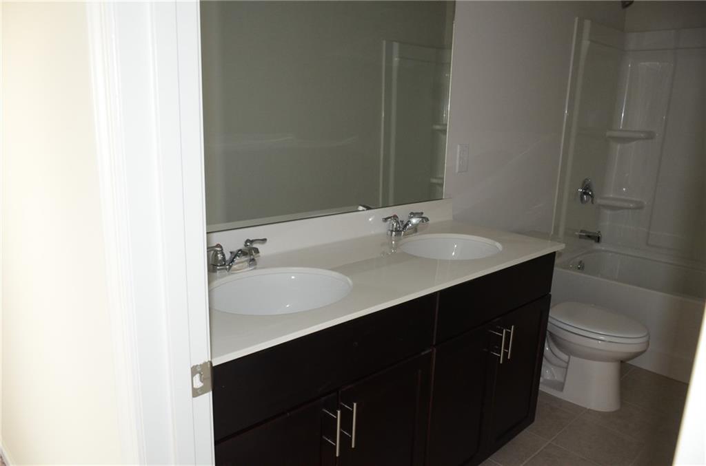226 Wells Circle Canton, GA 30114 - Photo 23 of 27 a bathroom with a sink and a mirror