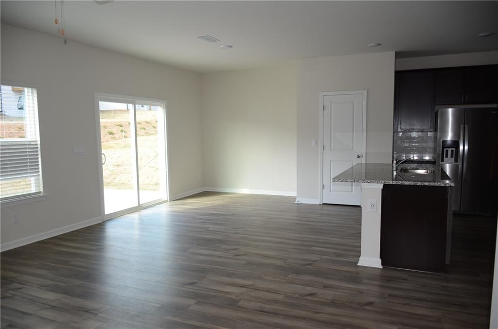 226 Wells Circle Canton, GA 30114 - Photo 7 of 27 an empty room with wooden floor and windows
