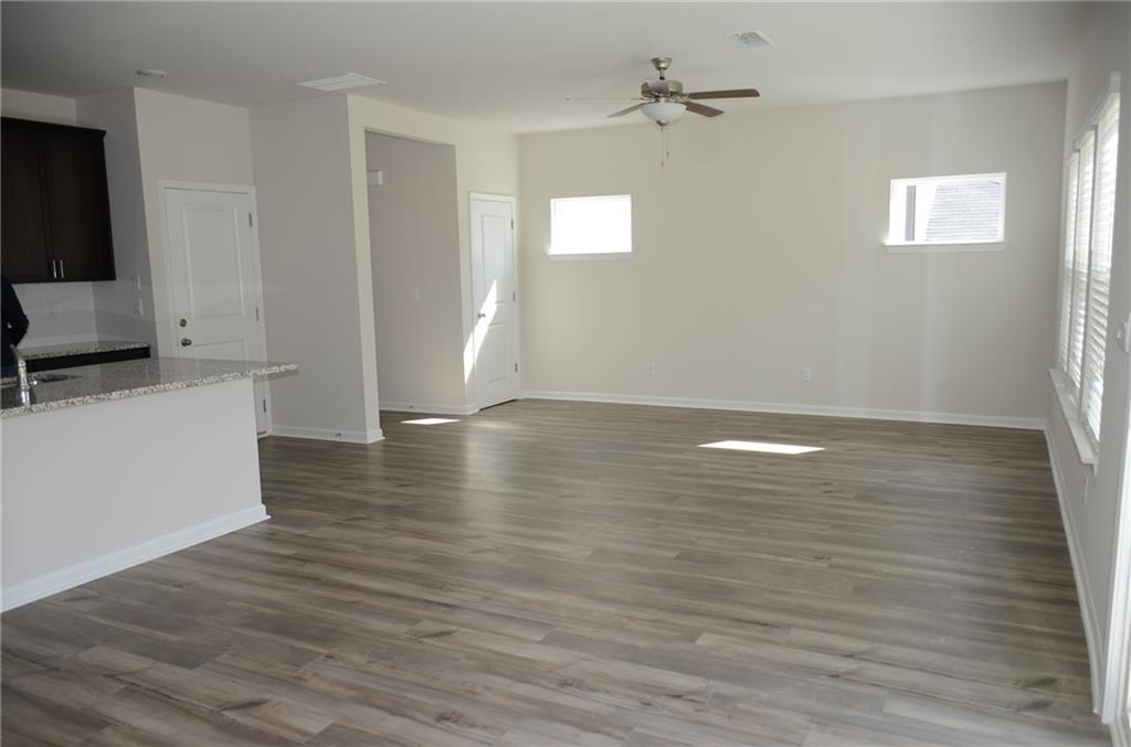226 Wells Circle Canton, GA 30114 - Photo 9 of 27 wooden floor in an empty room with a window