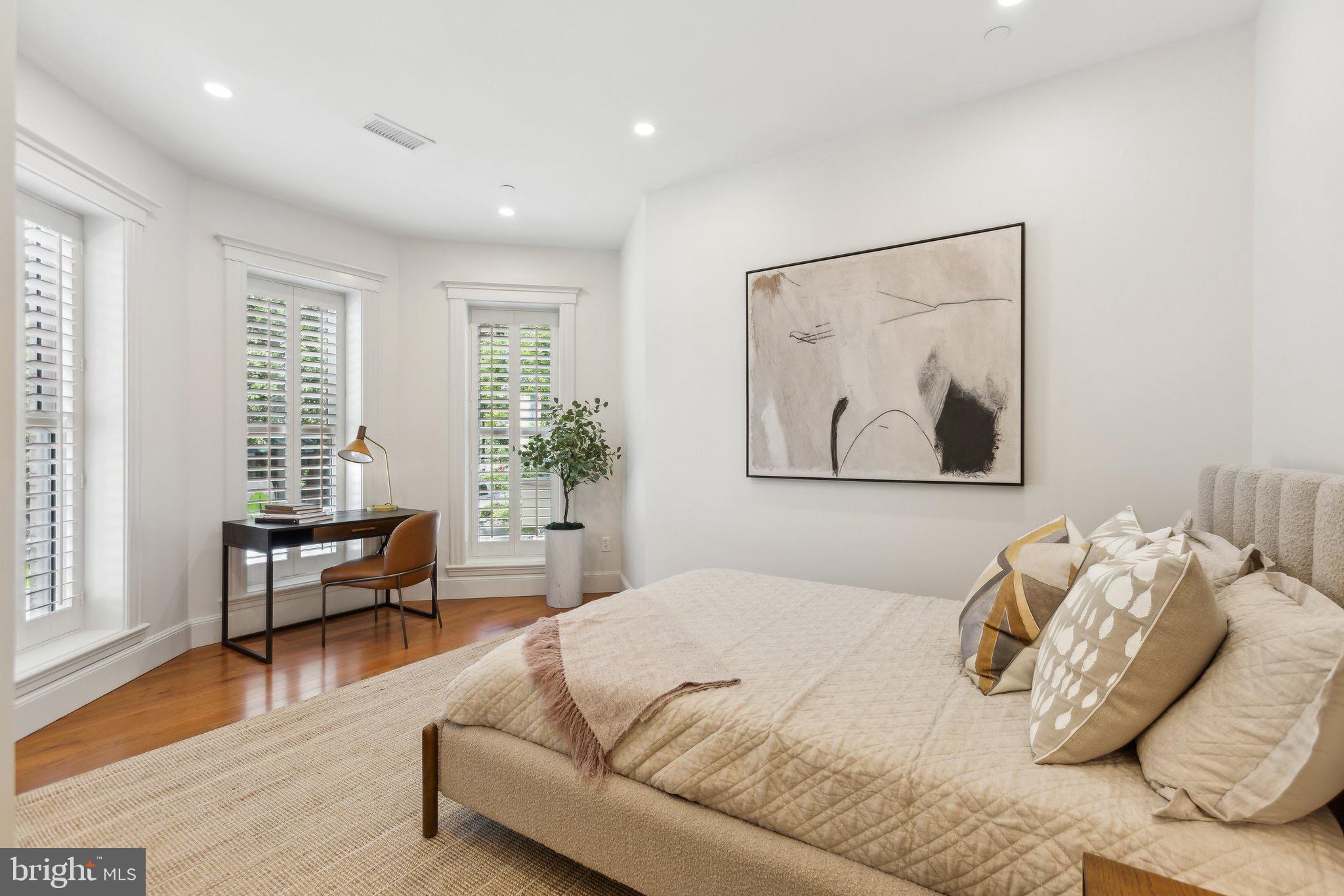 1641 R Street Northwest, Unit 403 Washington, DC 20009 - Photo 17 of 36 Serene bedroom with natural light and art.