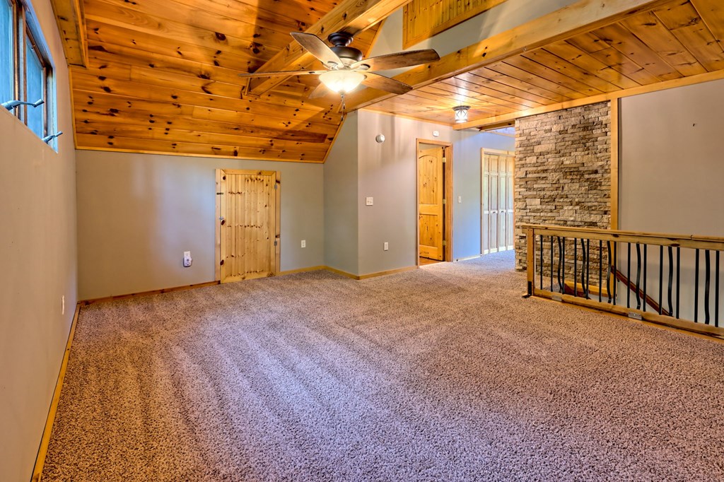 206 Peckerwood Road Hayesville, NC 28904 - Photo 22 of 75 Primary den/ flex/ bonus, Great for an exercise bike, a sofa and 2 armchairs and big TV. BR is adjacent. Put up a push back barn door for bedroom privacy! Great space!