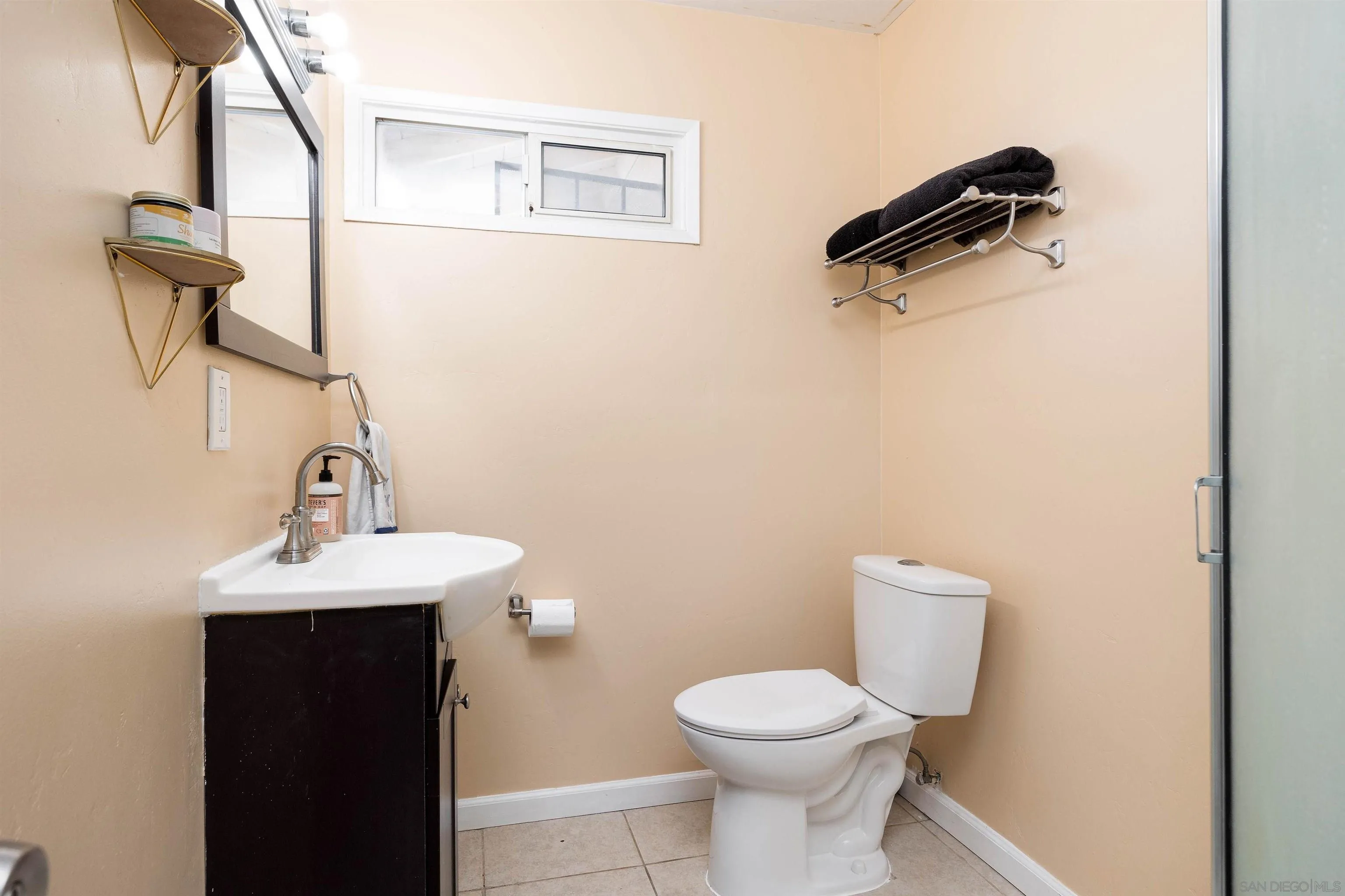 10203 Settle Road Santee, CA 92071 - Photo 14 of 33 a bathroom with a toilet sink and mirror