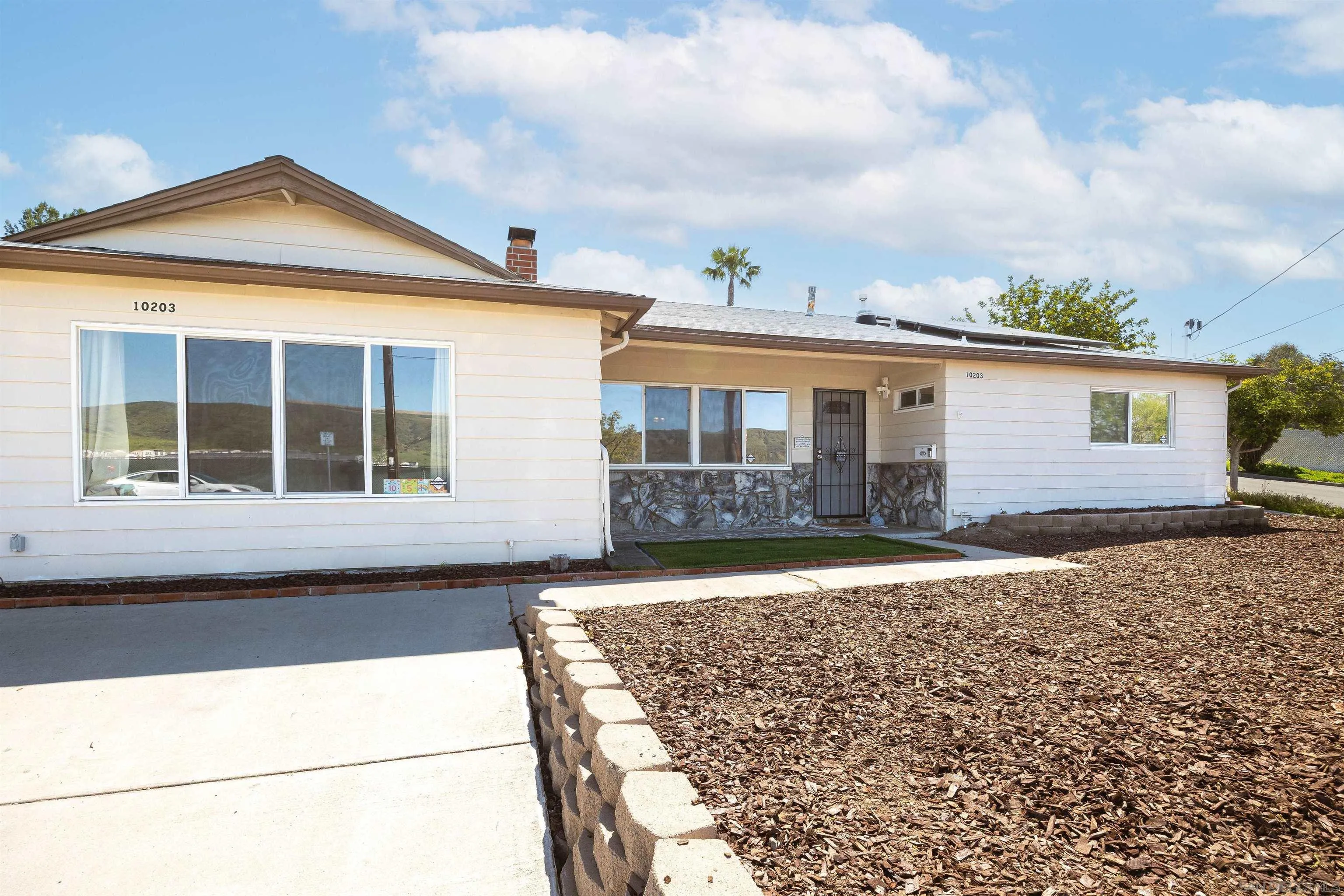 10203 Settle Road Santee, CA 92071 - Photo 3 of 33 a front view of a house with a yard