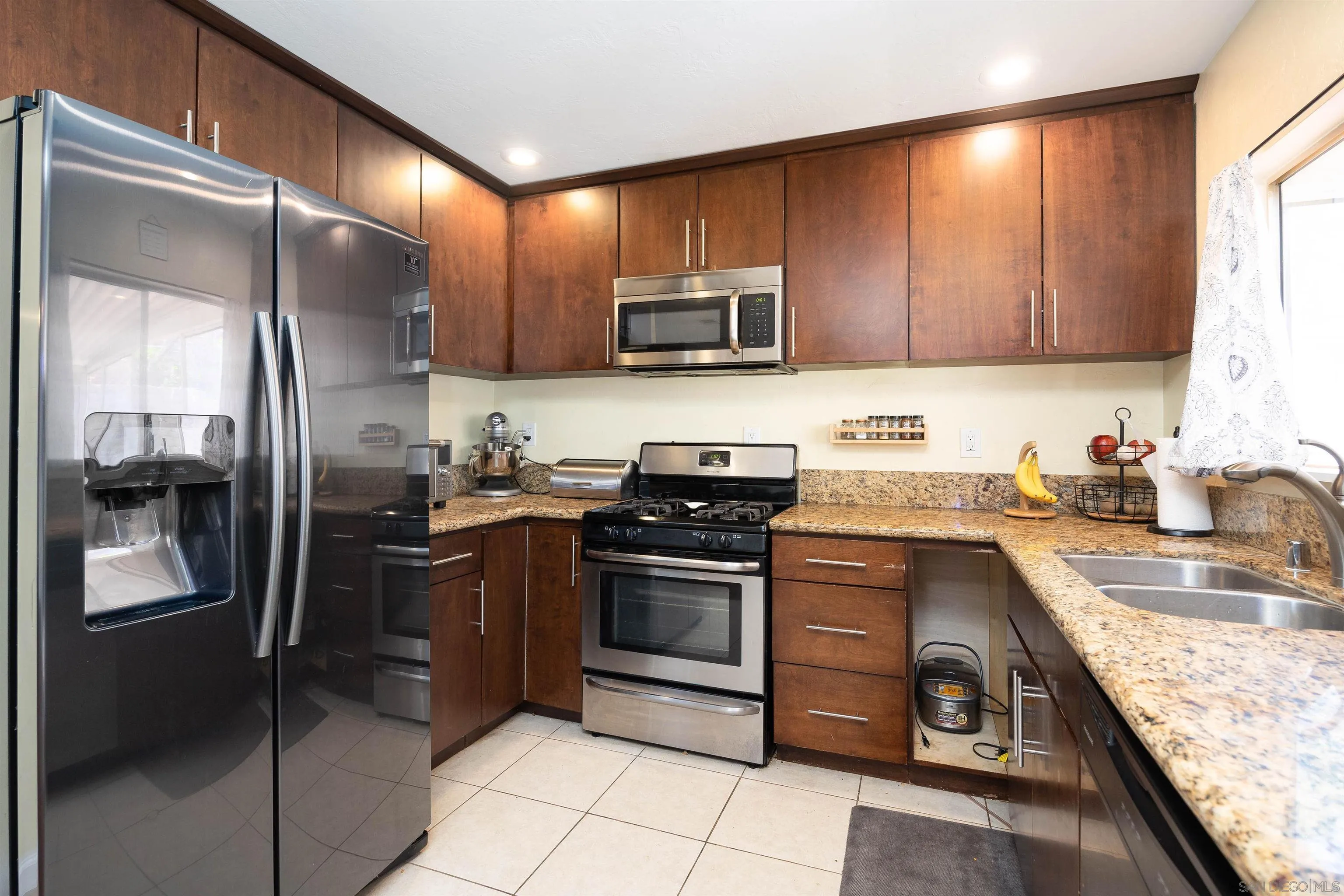 10203 Settle Road Santee, CA 92071 - Photo 7 of 33 a kitchen with stainless steel appliances granite countertop a refrigerator stove and sink