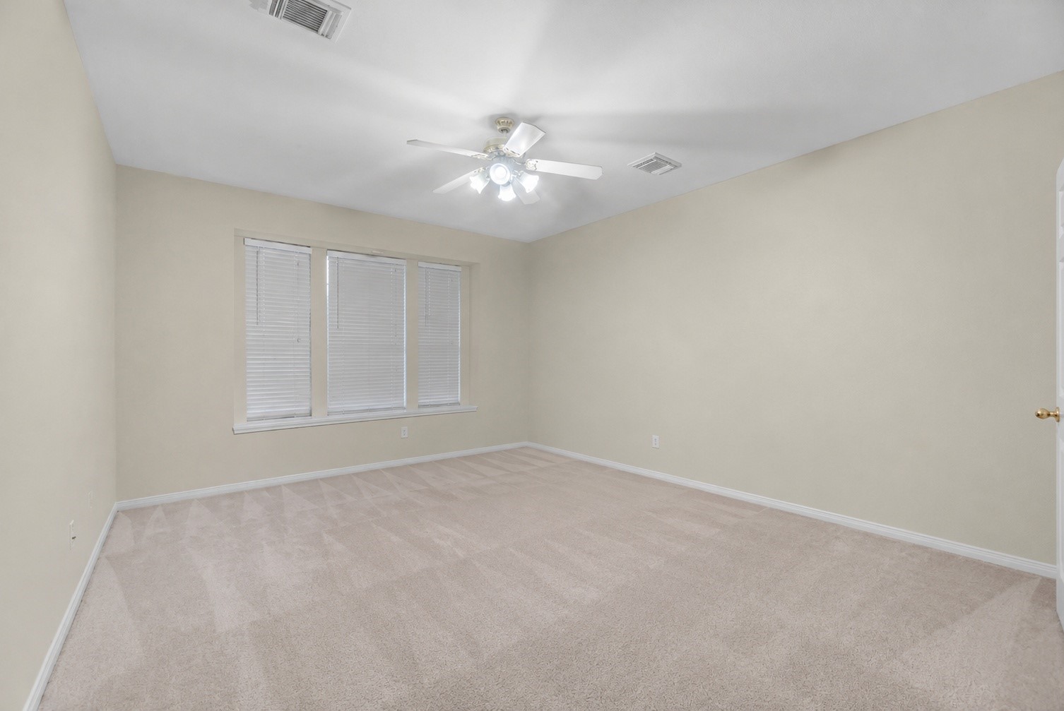 5724 Shady Hollow Court Rosharon, TX 77583 - Photo 23 of 27 Spacious primary suite shown virtually unfurnished to highlight the room’s generous layout and flexibility. Freshly shampooed carpet throughout the home adds a clean, move-in-ready feel, while the neutral walls and large window create a bright foundation for the next homeowner’s personal style. With plenty of room to design a relaxing retreat, this space offers tons of potential to become your own personal oasis. Virtually unfurnished.