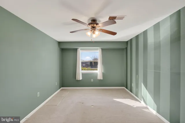 a view of a livingroom with a ceiling fan and window
