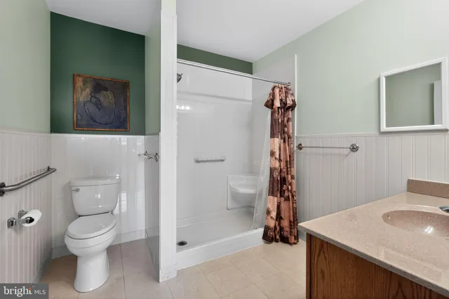 a bathroom with a shower toilet and sink