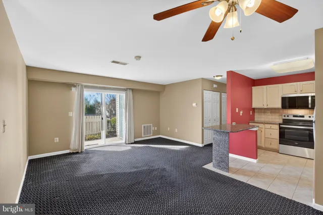 a view of livingroom with kitchen island furniture and ceiling fan