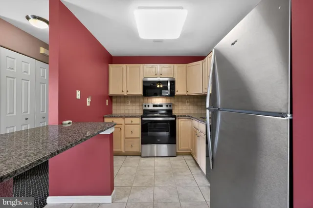 a kitchen with a refrigerator and a sink