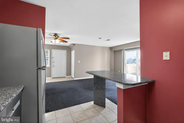 a view of kitchen with cabinets and window