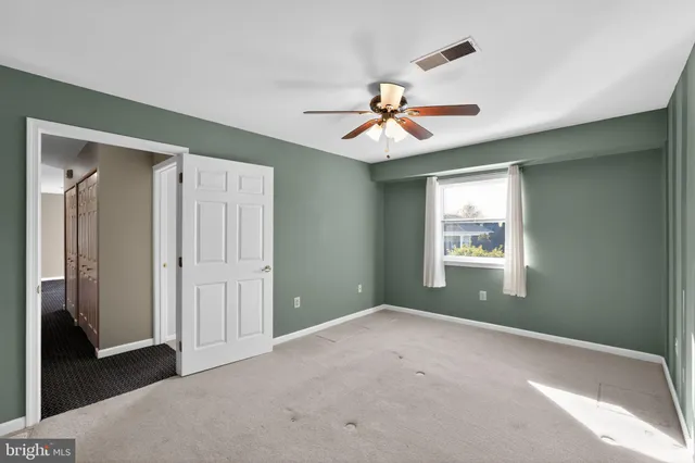 a view of a livingroom with a ceiling fan and window
