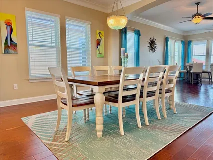 a room with stainless steel appliances kitchen island granite countertop a sink and a refrigerator