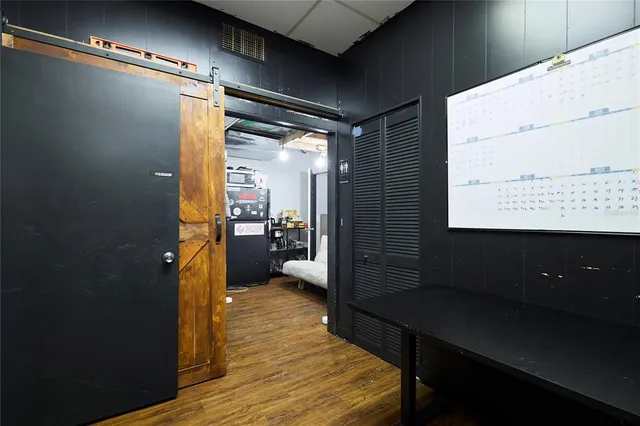 a view of a hallway with couch and wooden floor