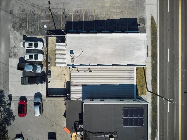 a view of roof deck with table and chairs with barbeque grill