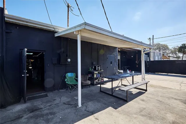 a view of a patio with table and chairs and potted plants