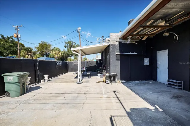 a view of a patio with a table and chairs